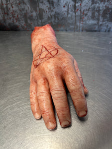 Severed male hand with pentagram