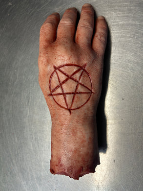 Severed male hand with pentagram