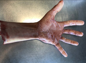 Severed male arm with fingers spread