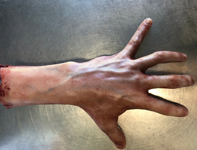 Severed male arm with fingers spread